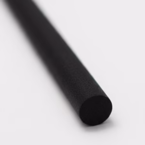 Black cylindrical diffuser refill reed on a clean white surface