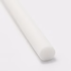 White cylindrical diffuser refill reed on a clean white surface in a minimalist setting