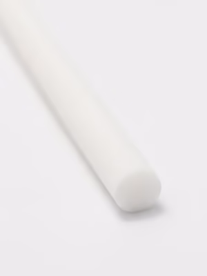 White cylindrical diffuser refill reed on a clean white surface in a minimalist setting