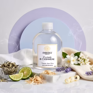 Amberly Essence Cloud & Cashmere diffuser refill bottle surrounded by linen, white tea leaves, lavender sprigs, and vanilla beans — luxury product photography.