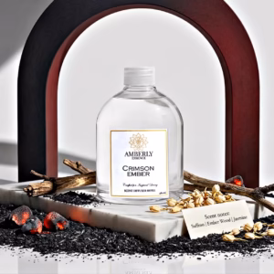 Amberly Crimson Ember diffuser refill styled with ember wood, saffron, jasmine and glowing ember elements on marble.