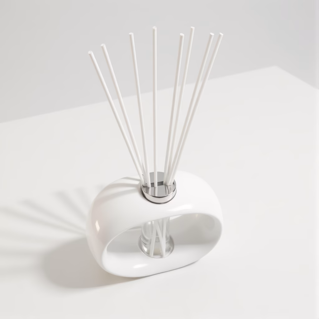 White porcelain torus reed diffuser with white fibre reeds on a white surface